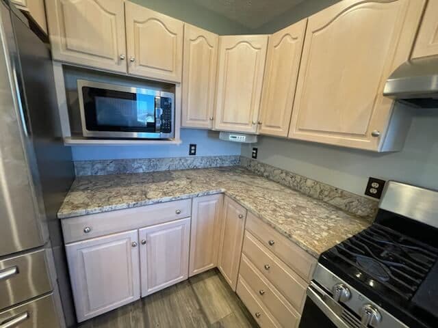 Remodeled kitchen with wood cabinetry